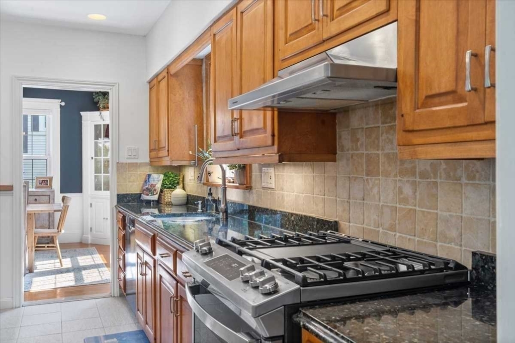 61 Havelock Road Worcester, MA 01602 - Photo 12 of 37 a kitchen with granite countertop a stove and a sink