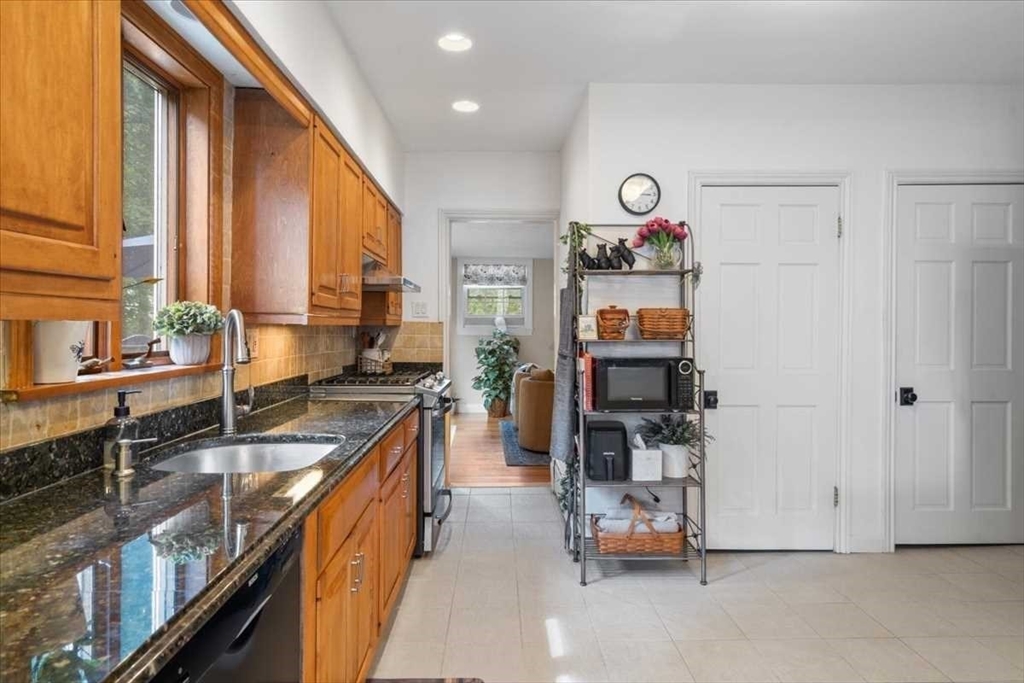 61 Havelock Road Worcester, MA 01602 - Photo 13 of 37 a kitchen with stainless steel appliances granite countertop a refrigerator and a stove
