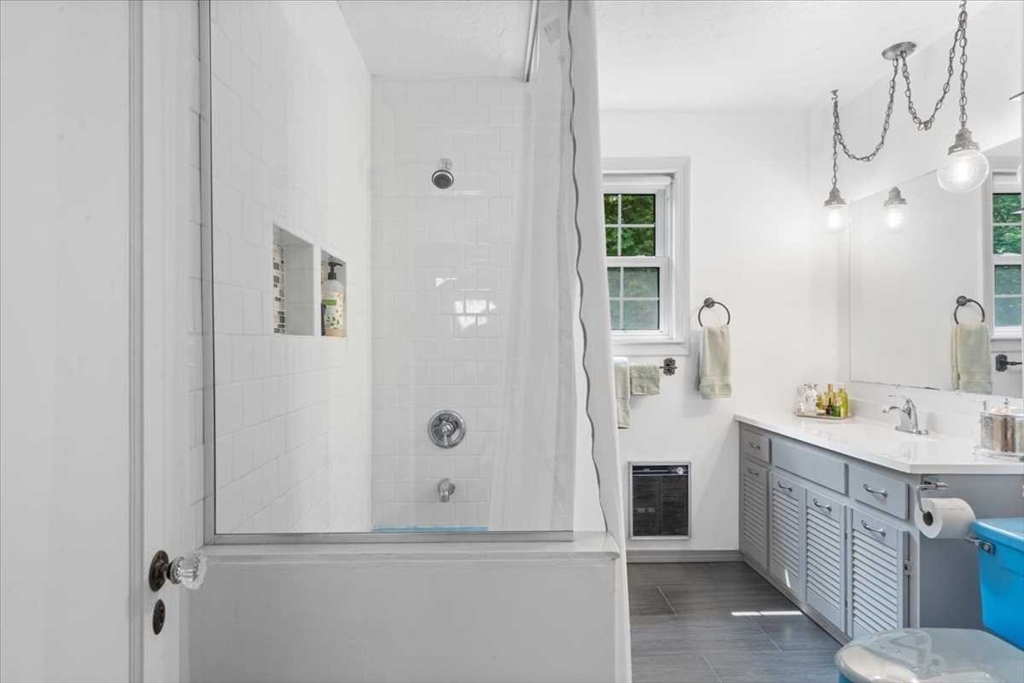 61 Havelock Road Worcester, MA 01602 - Photo 27 of 37 a bathroom with a double vanity sink a mirror and a shower