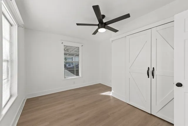 wooden floor in an empty room with a window