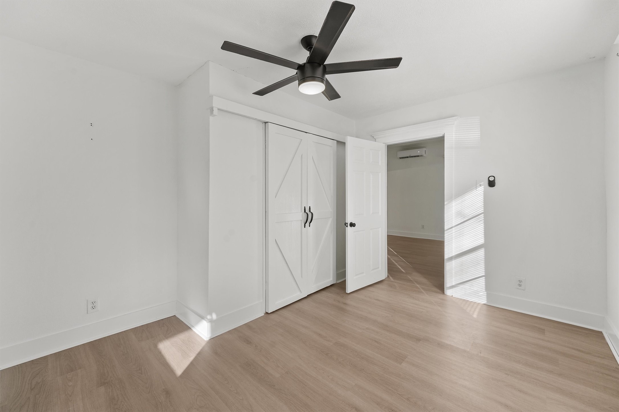 4029 Lucille Street Houston, TX 77026 - Photo 13 of 28 a view of a livingroom with a ceiling fan and wooden floor