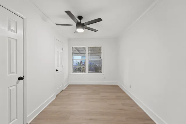a view of a big room with wooden floor closet and windows