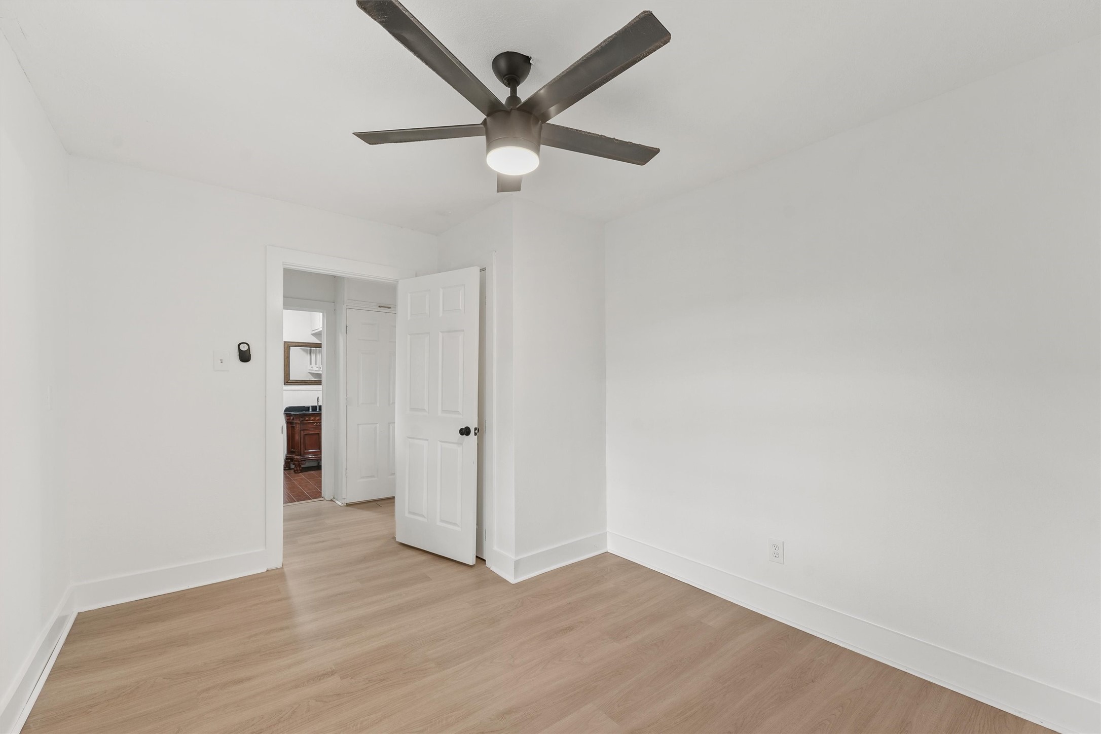 4029 Lucille Street Houston, TX 77026 - Photo 19 of 28 an empty room with wooden floor and ceiling fan