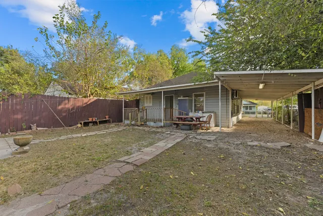 a view of a house with a yard and sitting area