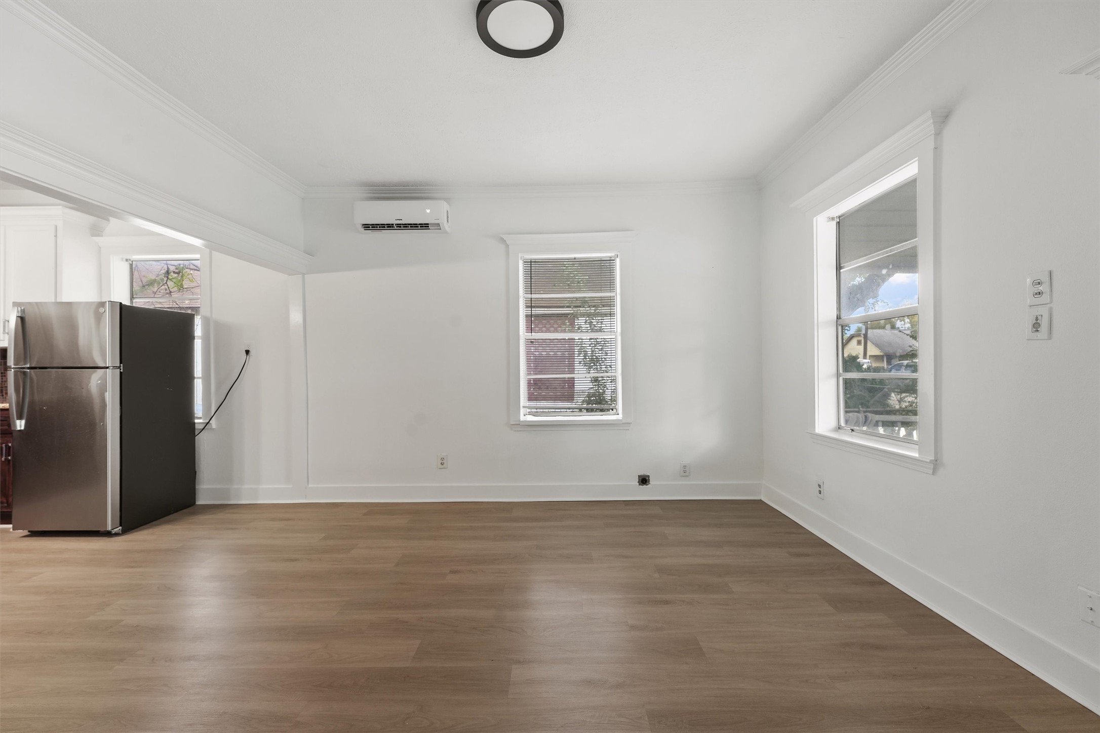 4029 Lucille Street Houston, TX 77026 - Photo 5 of 28 an empty room with wooden floor and windows