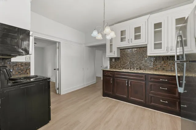 a kitchen with stainless steel appliances granite countertop a sink and cabinets