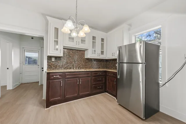 a kitchen with stainless steel appliances granite countertop a refrigerator a oven and a sink