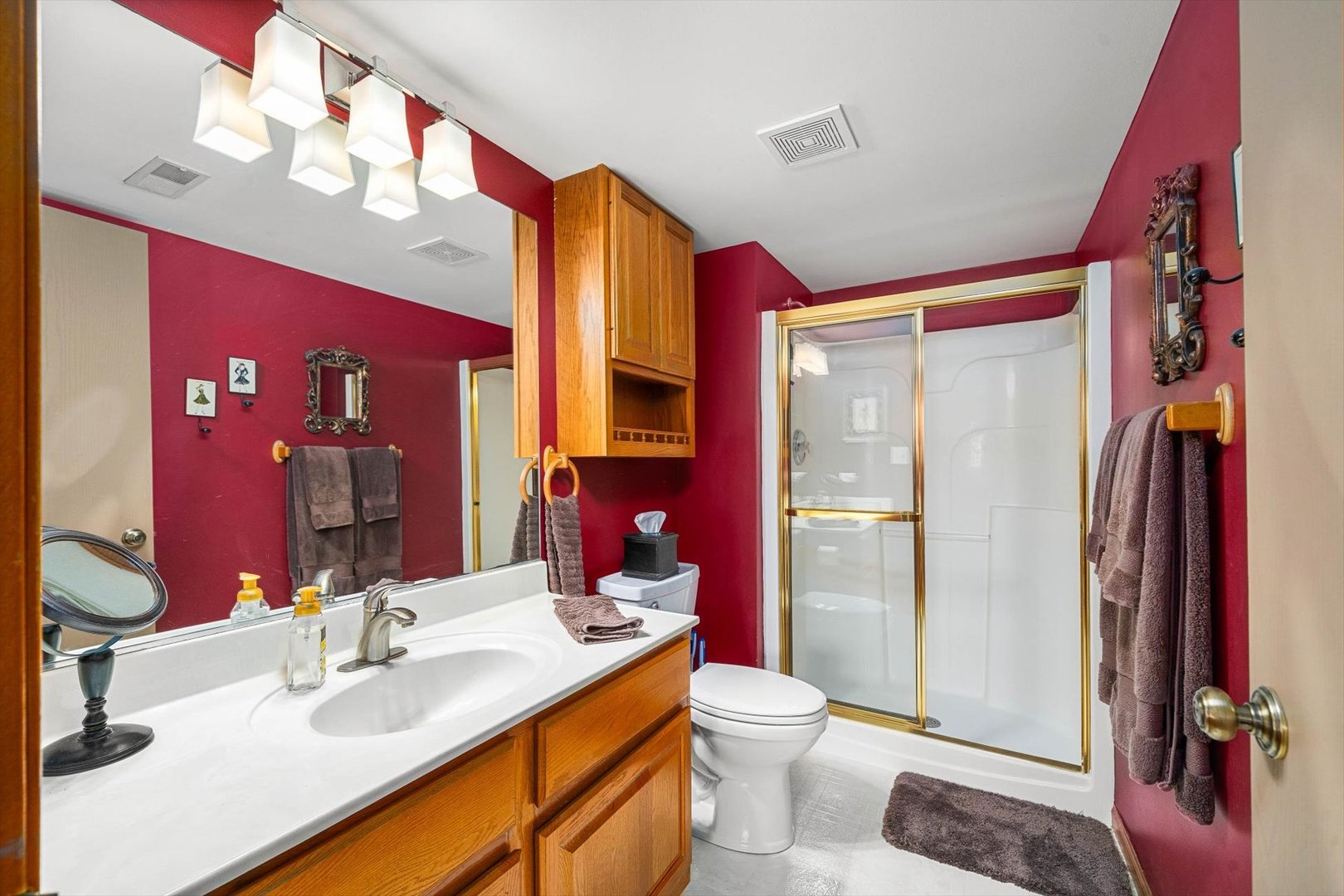 431 Badger Lane Oswego, IL 60543 - Photo 10 of 19 a bathroom with a sink vanity mirror and toilet
