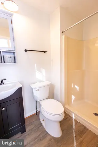 a white toilet sitting next to a bathroom sink
