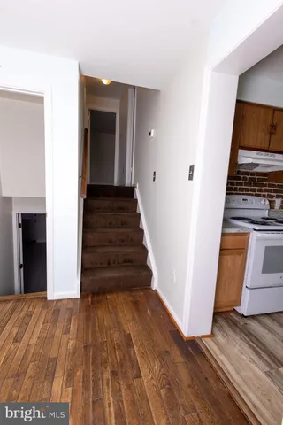 a view of a hallway view with wooden floor and staircase