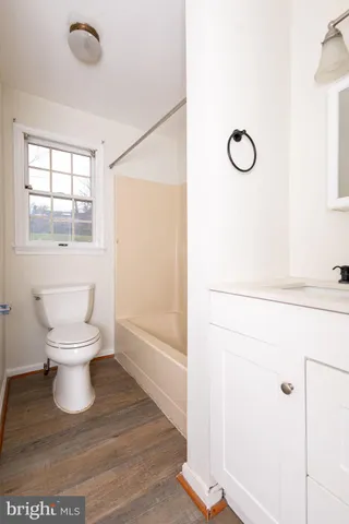 a white toilet sitting next to a bathroom sink
