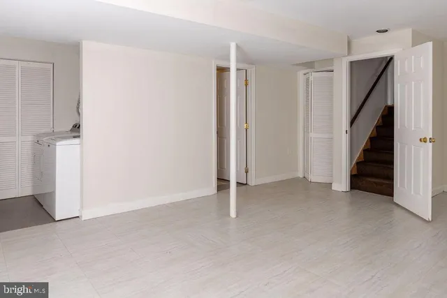 a view of an empty room with stairs