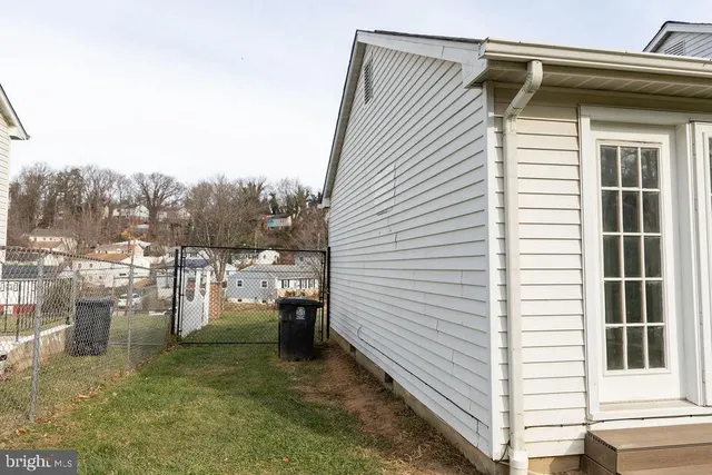 a view of a back yard of the house and a chair