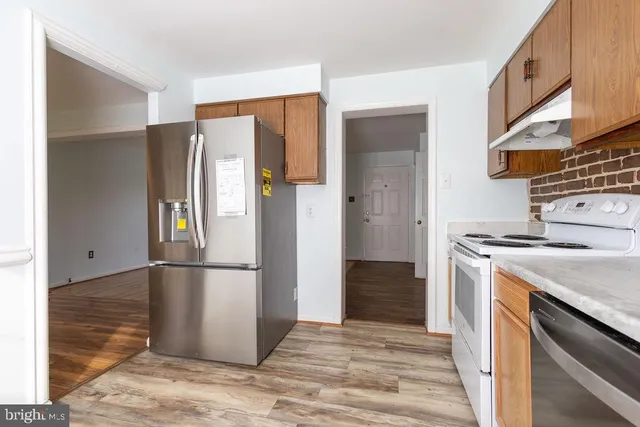 a kitchen with a refrigerator and a stove