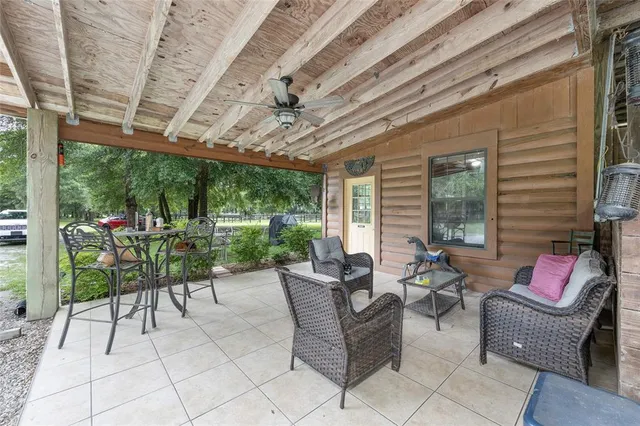 a living room with furniture and a open kitchen view