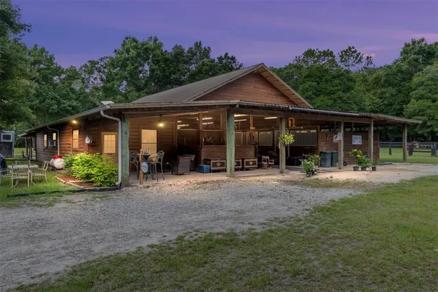a front view of a house with a yard and glass windows