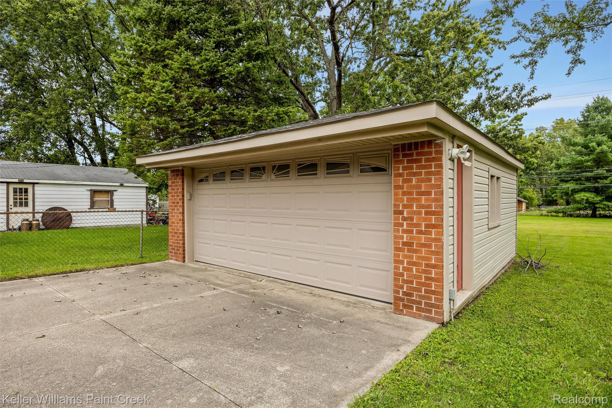 1766 Henry Ruff Road Garden City, MI 48135 - Photo 30 of 36 Detached garage featuring brick and siding exterior, a sectional garage door with upper window panels, and a concrete driveway
