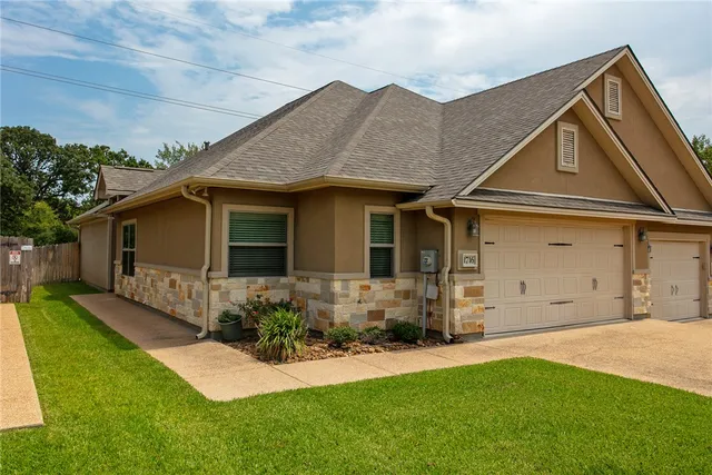a front view of a house with a yard and porch