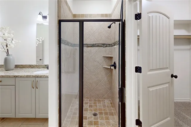 a bathroom with a granite countertop shower mirror and a sink
