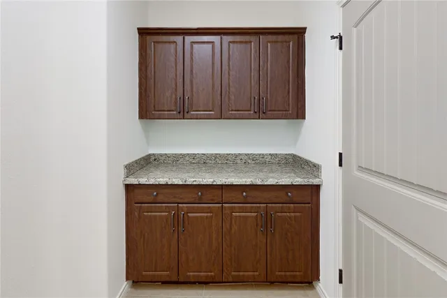 an empty room with wooden floor and cabinet
