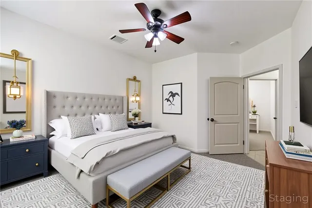 a bedroom with bed and a chandelier