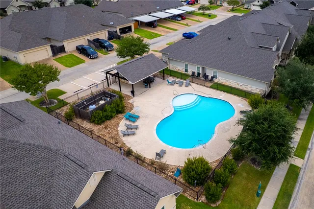 an aerial view of a house with a swimming pool