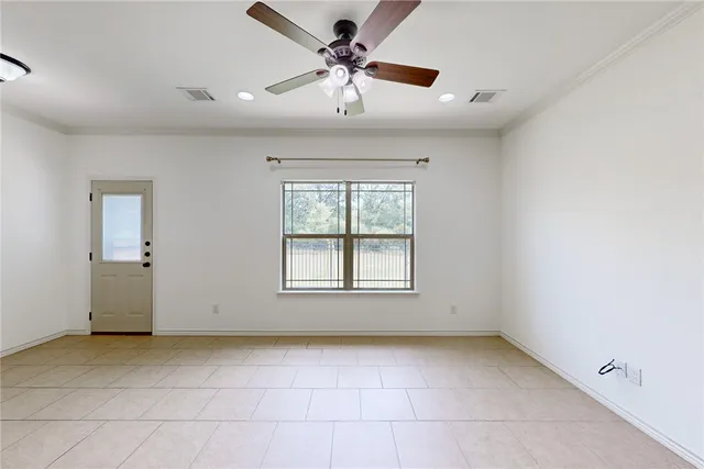 a view of a livingroom with a ceiling fan and window