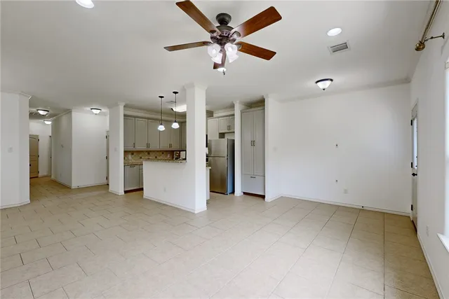 a view of an empty room with a kitchen