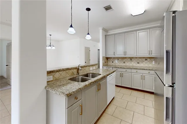 a kitchen with a sink window and cabinets