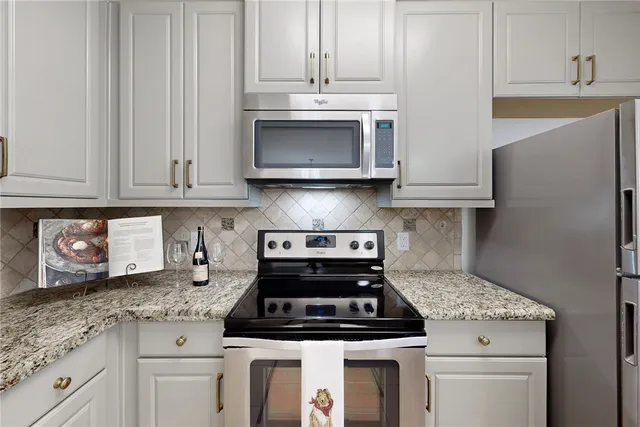 a stove top oven sitting inside of a kitchen