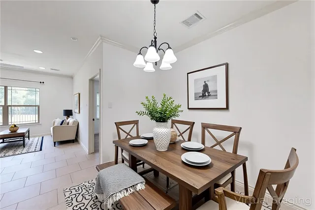 a view of a dining room with furniture and chandelier