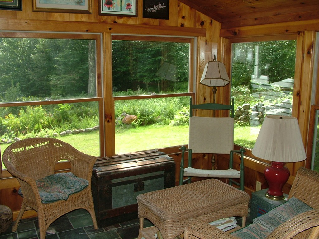 65 Potter Road Rowe, MA 01367 - Photo 17 of 30 a living room with patio furniture and a floor to ceiling window