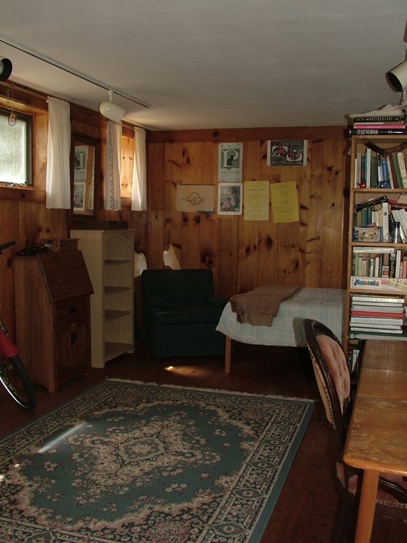 65 Potter Road Rowe, MA 01367 - Photo 19 of 30 a living room with furniture a bookshelf and a window