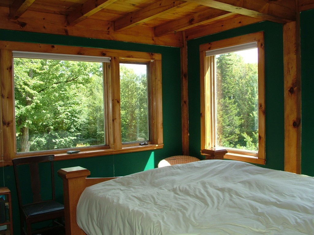 65 Potter Road Rowe, MA 01367 - Photo 23 of 30 a bed sitting in a bedroom next to a window