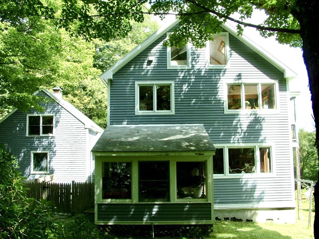 65 Potter Road Rowe, MA 01367 - Photo 4 of 30 a view of a house with brick walls and a large tree