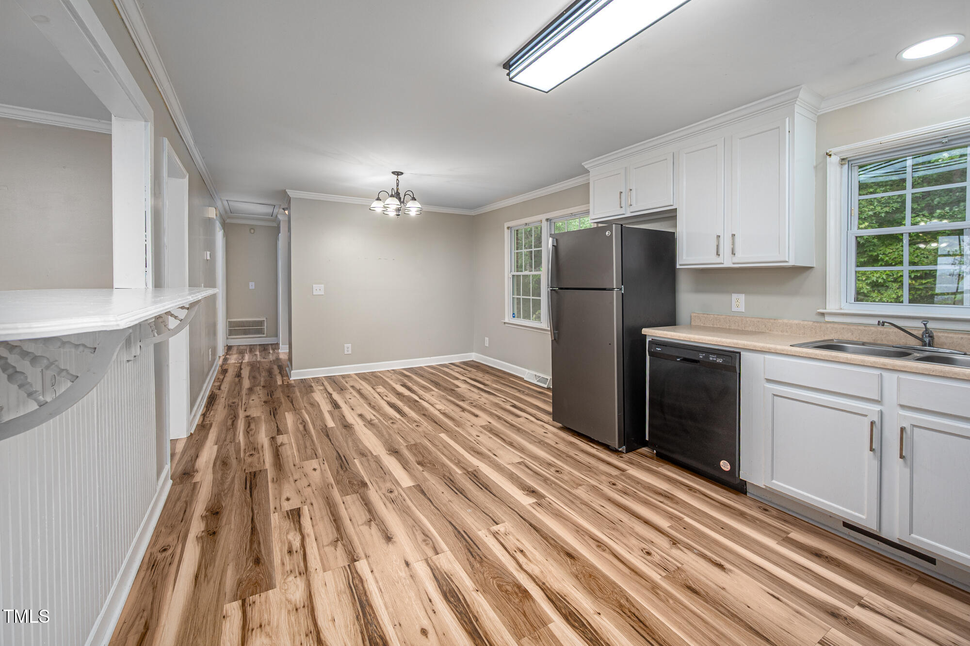 714 Dick Holeman Road Timberlake, NC 27583 - Photo 11 of 25 a kitchen with a sink a refrigerator and cabinets