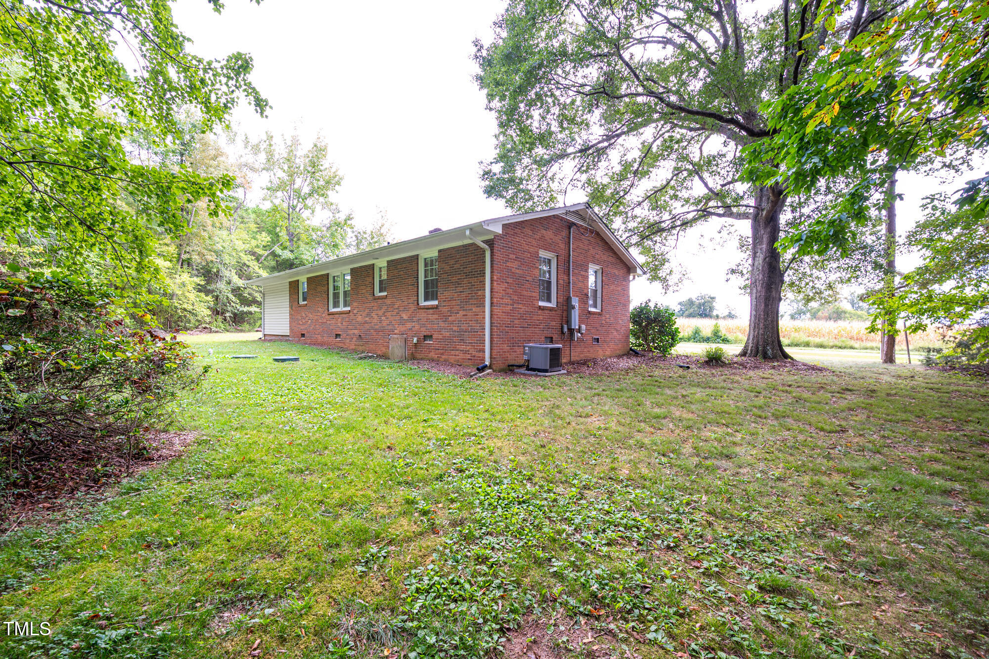 714 Dick Holeman Road Timberlake, NC 27583 - Photo 24 of 25 a view of backyard with a garden and large trees