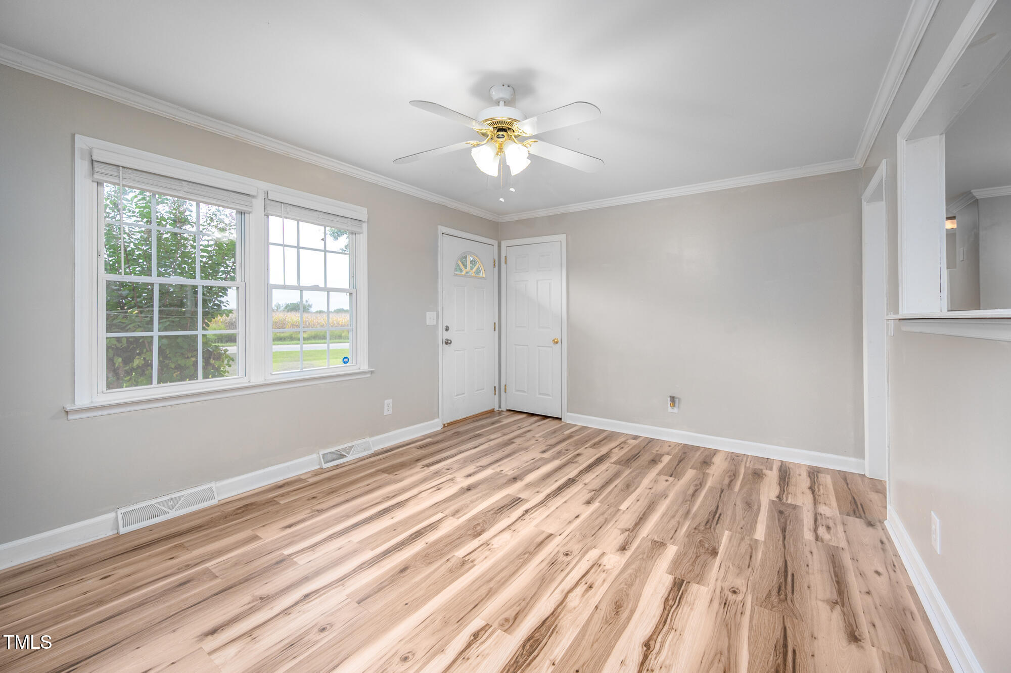 714 Dick Holeman Road Timberlake, NC 27583 - Photo 6 of 25 a view of an empty room with wooden floor and a window