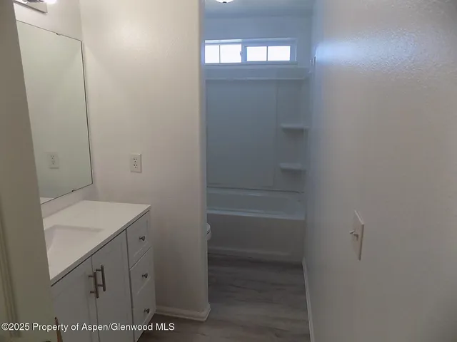 a bathroom with a sink and vanity