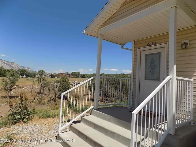 a view of a balcony with wooden floor and fence