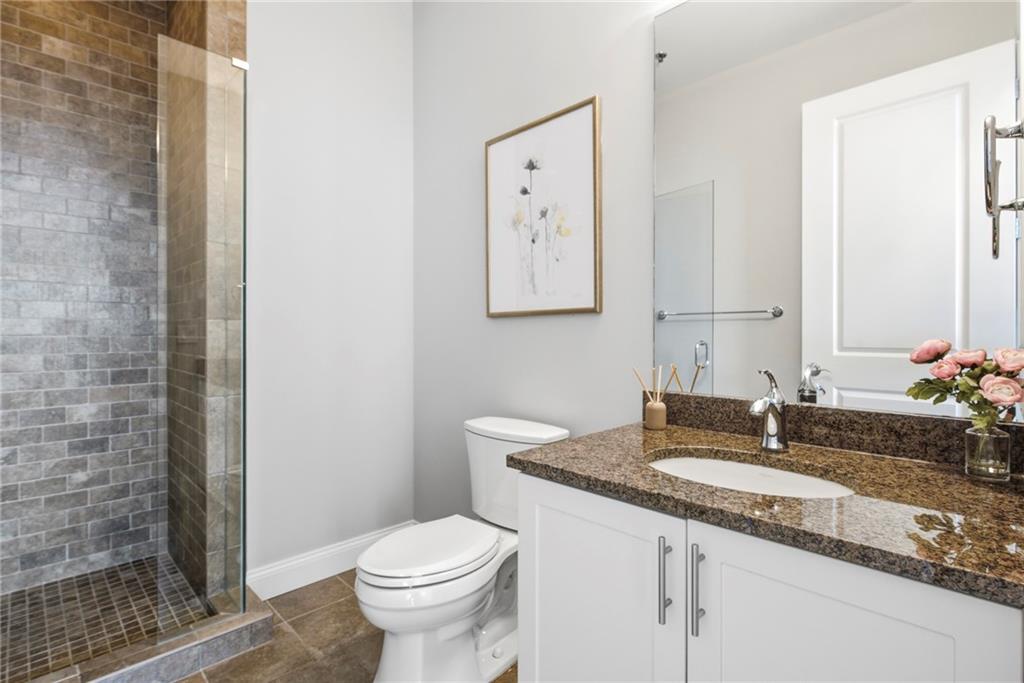 270 17th Street Northwest, Unit 4306 Atlanta, GA 30363 - Photo 21 of 37 a bathroom with a granite countertop sink toilet and mirror