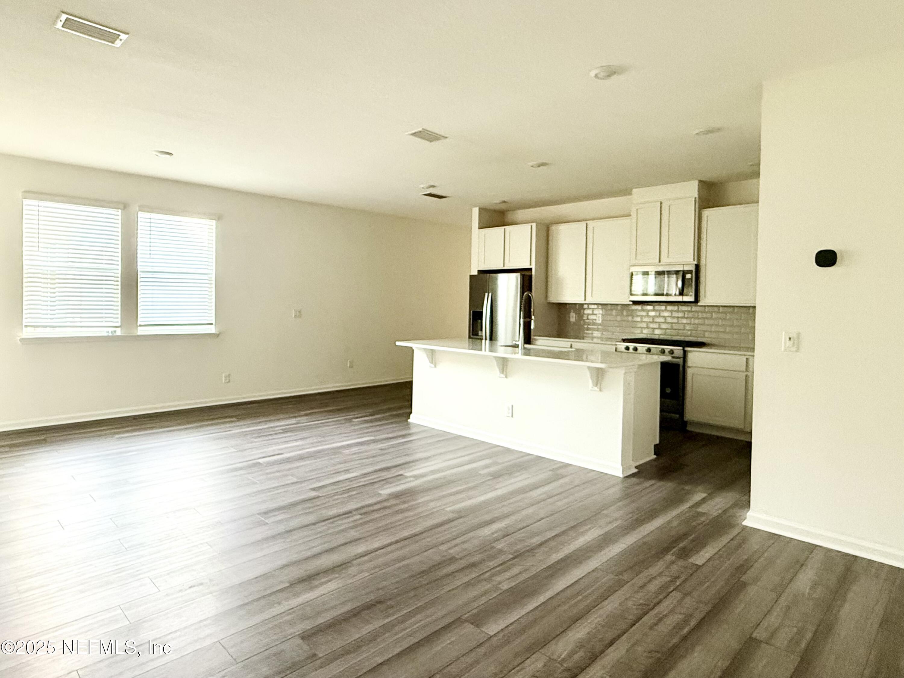 216 Rambling Brk Trail St. Johns, FL 32259 - Photo 11 of 24 a view of a kitchen with a sink wooden cabinets and a window