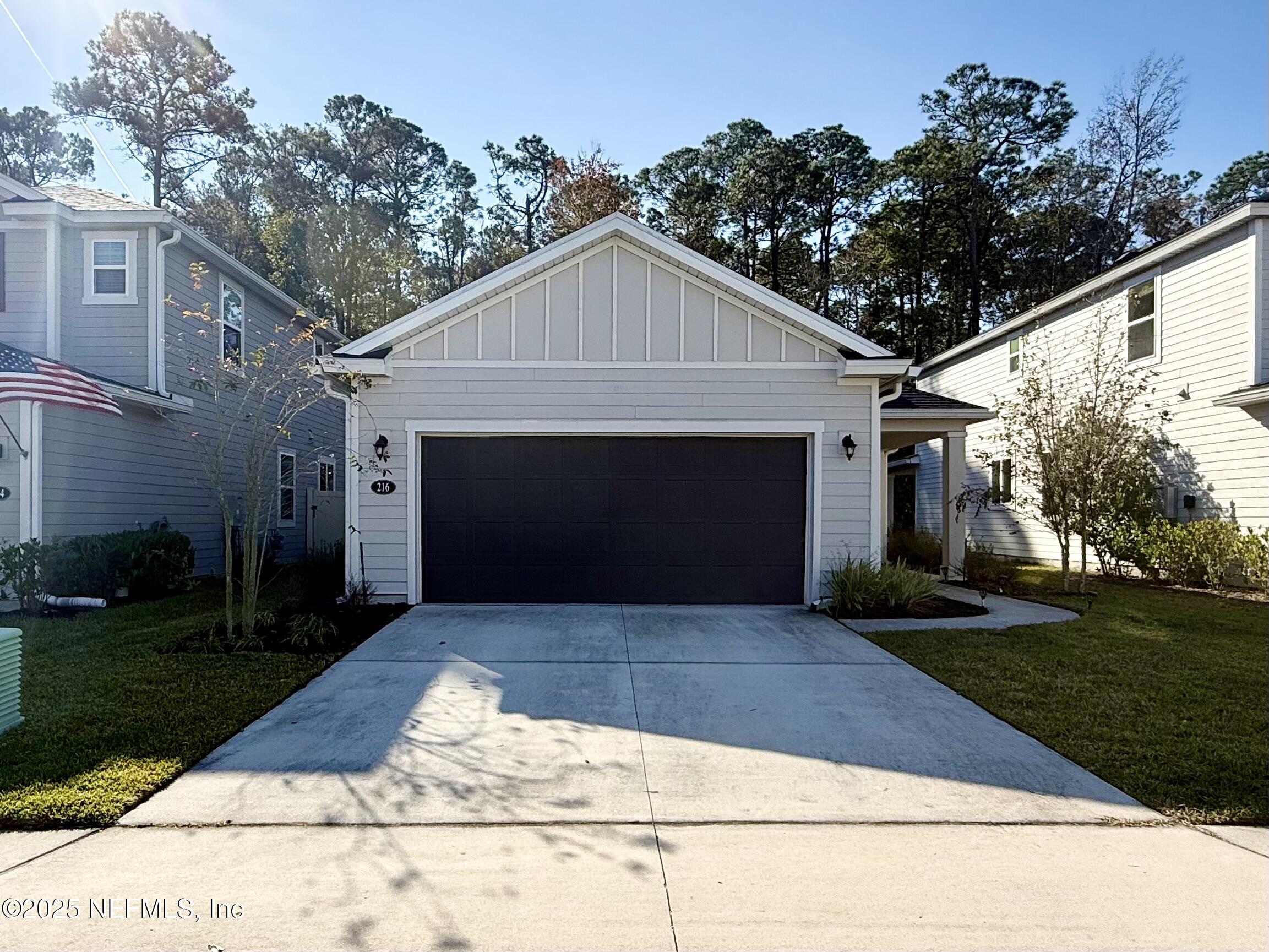 216 Rambling Brk Trail St. Johns, FL 32259 - Photo 2 of 24 a front view of a house with yard