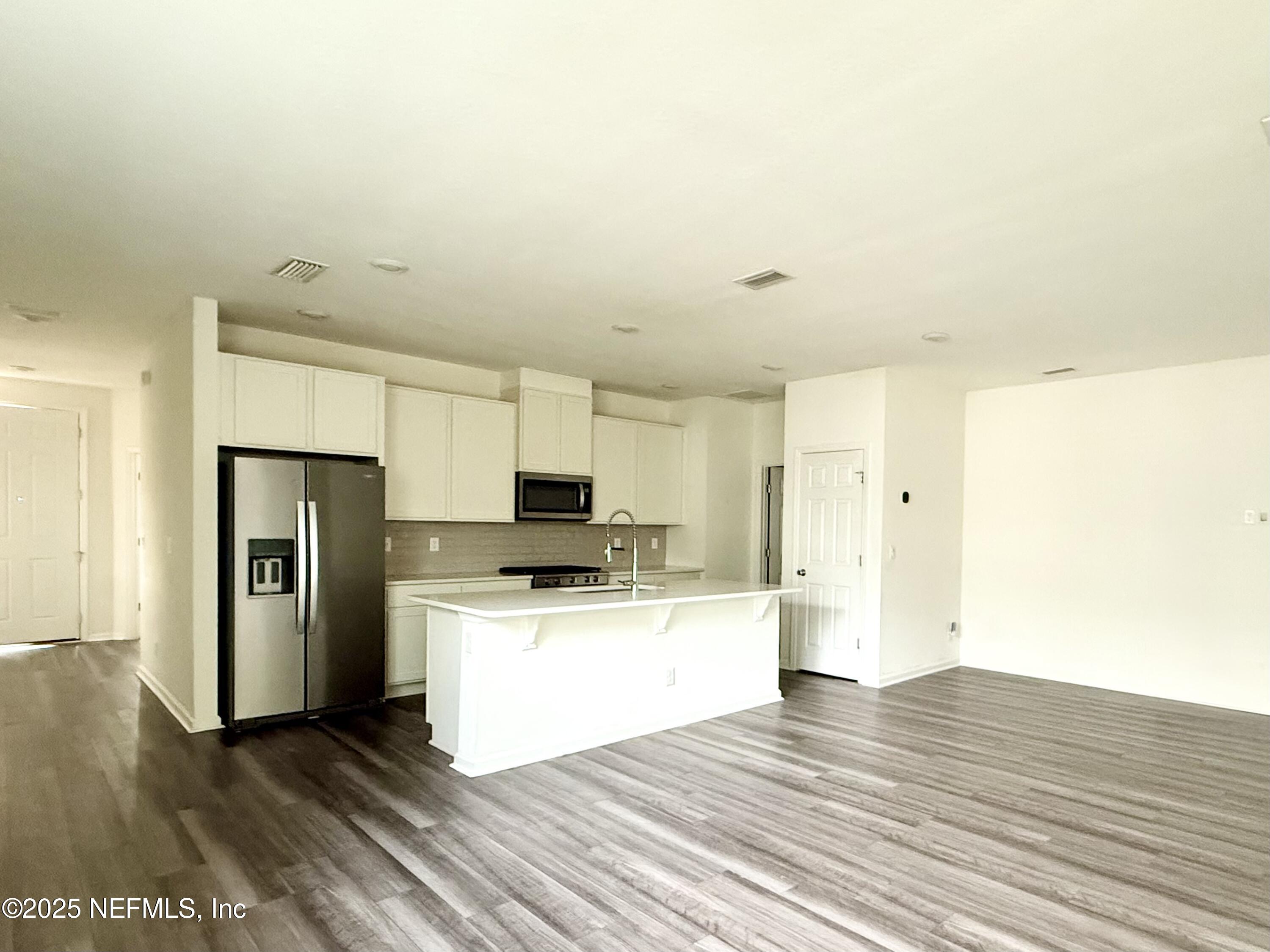 216 Rambling Brk Trail St. Johns, FL 32259 - Photo 9 of 24 a view of a kitchen with a sink and a refrigerator