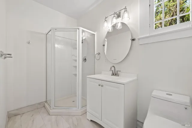 an empty room with wooden floor and a fireplace
