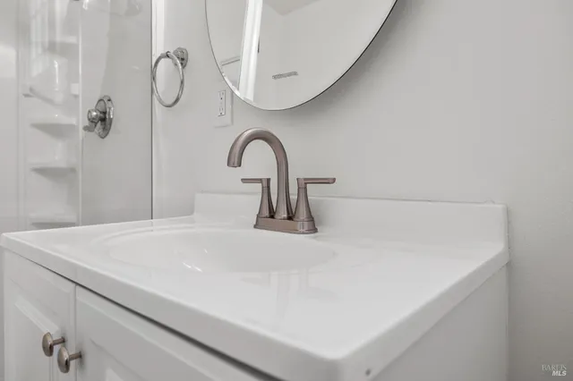 a view of empty room with wooden floor and fireplace