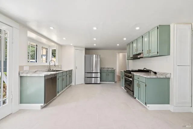 a view of an empty room with wooden floor and a ceiling fan