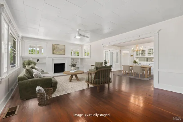 a living room with furniture a fireplace and a table