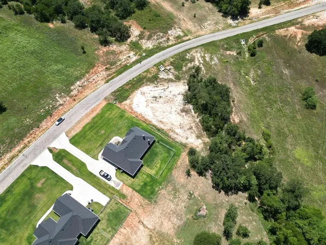 a view of a yard with a wooden fence