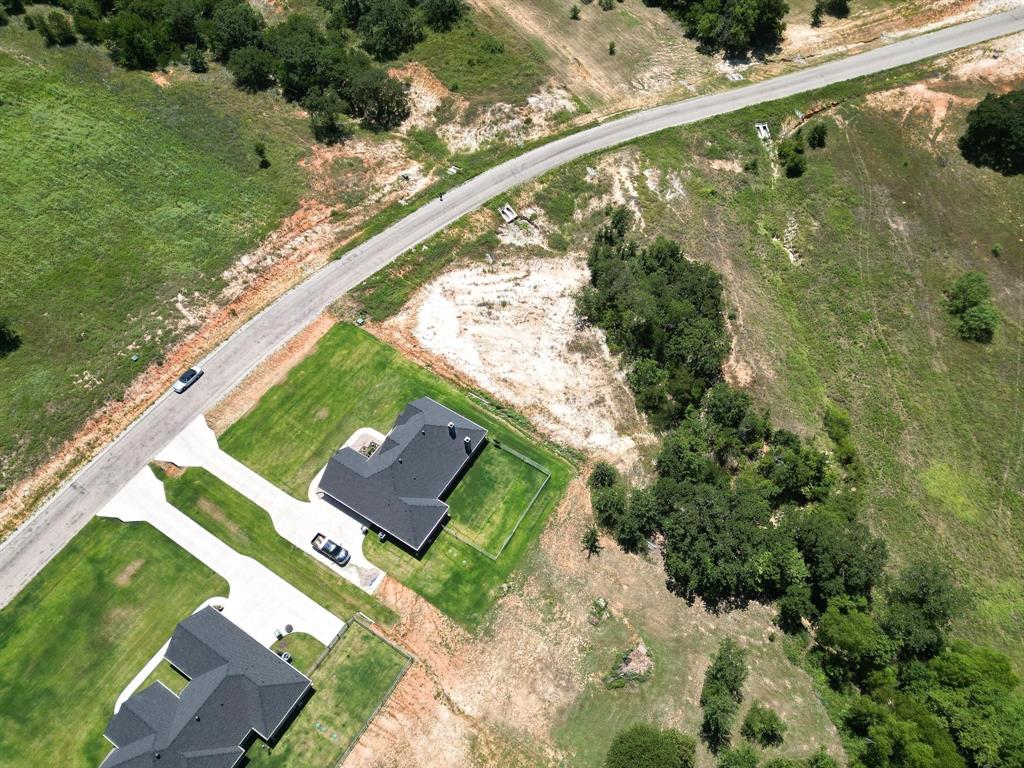 1077 Gonzollas Road Springtown, TX 76082 - Photo 8 of 16 a view of a yard with a wooden fence